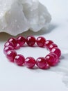 Bracelet with red garnet beads on white background. Royalty Free Stock Photo